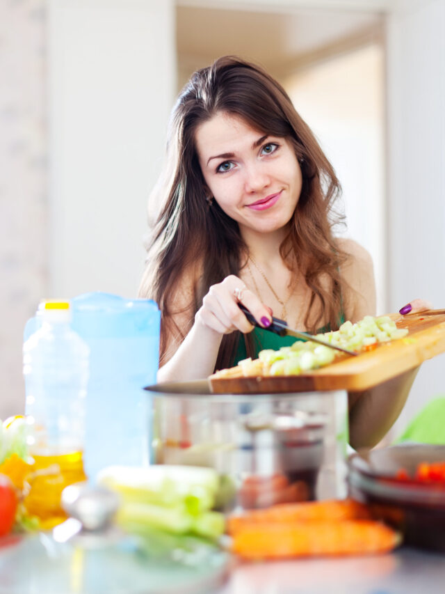 beautiful woman cooking vegetarian salad