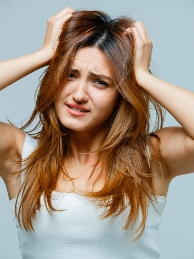 young lady holding hands on head in singlet and looking confused. front view.